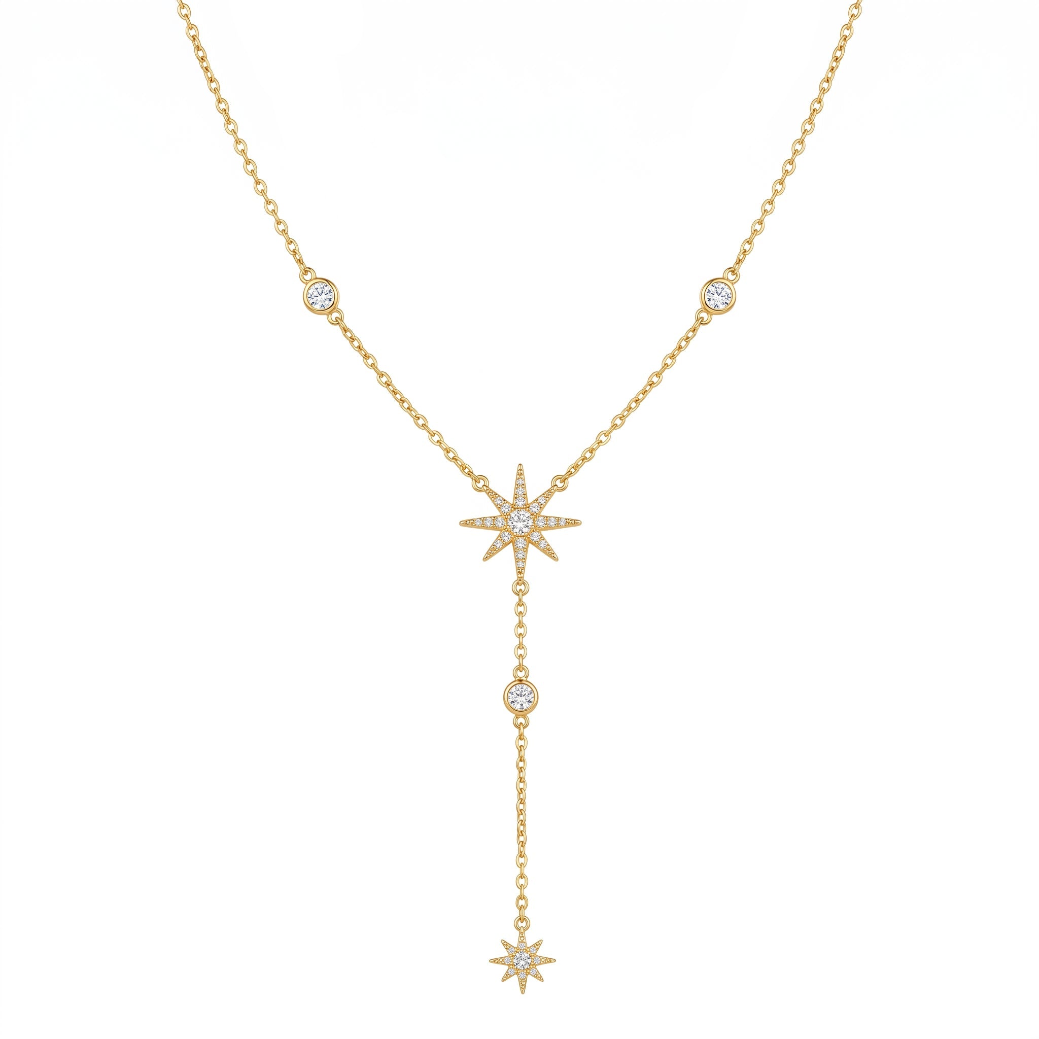A gold double-layered necklace featuring a Y-shaped drop design with three starburst charms, each adorned with small clear pavé stones, and accent round bezel-set stones along the chain, shown on a plain white background.
