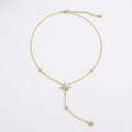 A delicate gold Y-shaped necklace featuring three starburst charms and small round pearl-like beads, displayed on a clean white background.